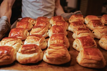 Closeup of freshly baked croissants laid out on a baking tray