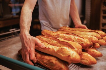 Baker working in the kitchen, preparing loaves of bread