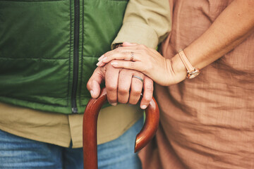 Closeup, hands and couple with support, cane and retirement with solidarity, marriage or...