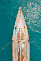 Aerial, ocean and women with phone on boat relax for cruise, luxury sailing and transport on sea....