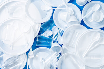Disposable waste plastic on blue background.