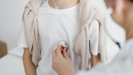 Doctor is examining a kid patient with a stethoscope. Perfect health concept in medicine