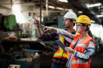 Caucasian woman programmer engineer and indian man Technician operator machine is working in...