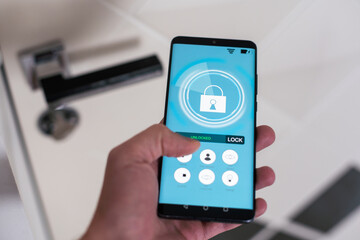 smart house, home automation, device with app icons. Man uses his smartphone with smarthome security app to unlock the door of his house.