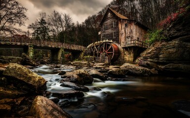 Stunning picturesque river runs alongside a historic old water mill © N0x/Wirestock Creators