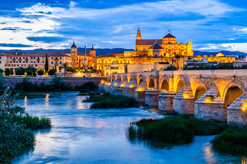 Cordoba, Andalusia, Spain: Twilight view of the old town with the ancient Mosque and Roman Bridge over Guadalquivir river - 618454532