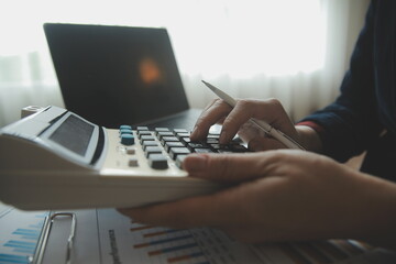 Unrecognizable businessman using calculator