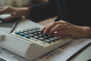 Unrecognizable businessman using calculator