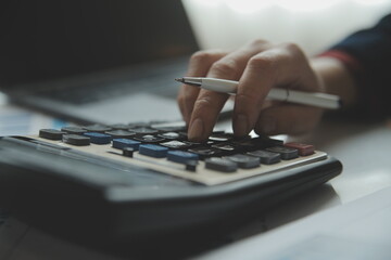 Fototapeta premium Unrecognizable businessman using calculator
