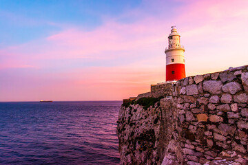 Fototapeta na wymiar The lighthous in Gibraltar at sunset on a rock by the shores of the Mediterranean Sea
