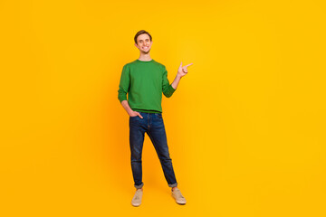 Photo of confident promoter guy direct finger suggest empty space wear pullover isolated yellow color background