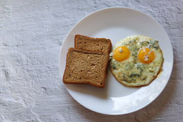 delicious breakfast.healthy food.scrambled eggs with blue cheese.idea for breakfast.toast bread with scrambled eggs on a white plate.diet.fried eggs on a plate.interesting combination of products.cook