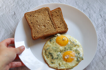 delicious breakfast.healthy food.scrambled eggs with blue cheese.idea for breakfast.toast bread with scrambled eggs on a white plate.diet.fried eggs on a plate.interesting combination of products.cook