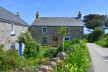 Pretty country lane with verdant hedgerows charming cottages on St Agnes on the beautiful Isles of Scilly  U.K.