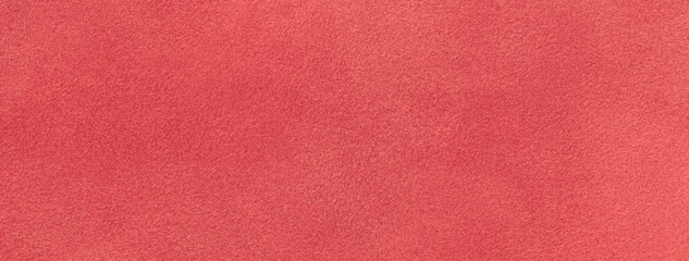 Texture of velvet matte red background, macro. Suede fabric with maroon pattern.