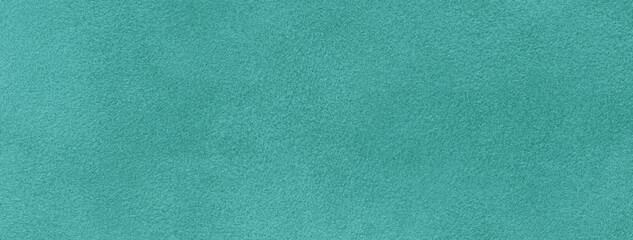 Texture of velvet matte light cyan background, macro. Suede fabric with sea green pattern.