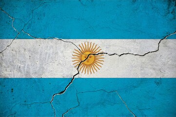An image of the Argentina flag on a wall with a crack.