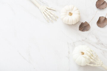 white halloween pumpkins with decor on marble background