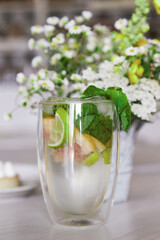 Summer non-alcoholic mojito with fresh mint in the cafe interior. Refreshing drink