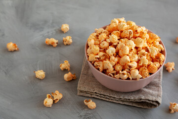 Homemade Cheese Popcorn in a Bowl on a gray background, side view.