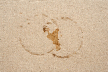 Cardboard texture with wet spots. Brown cardboard with round wet spots of water. Crumpled cardboard with surface texture
