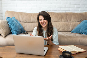 Young woman talking on video call with her psychotherapist doctor after online therapy sessions,...