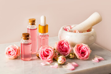 A set of natural cosmetics for face and body skin care based on rose oil in various bottles and a...