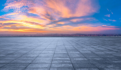 Empty square floors and city skyline with colorful sky clouds at sunset