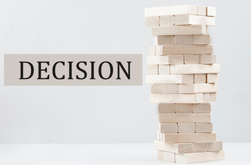 DECISION text with wooden block stack on white background , business concept