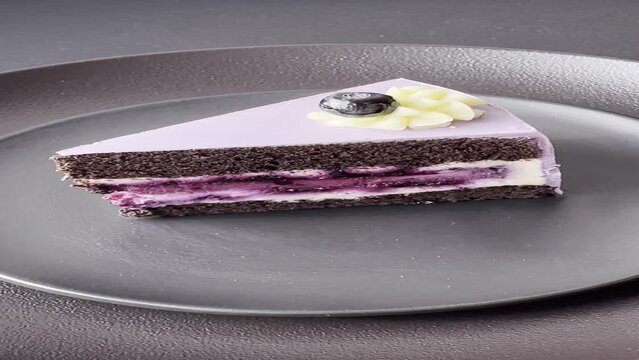 Delicious fresh blueberry or blackcurrant cake with cream cheese on a dark concrete background