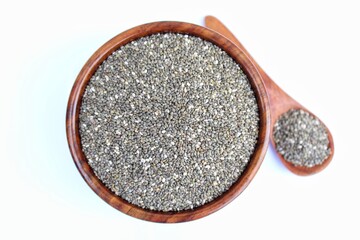 Chia seeds in a wooden bowl on white background top view 
