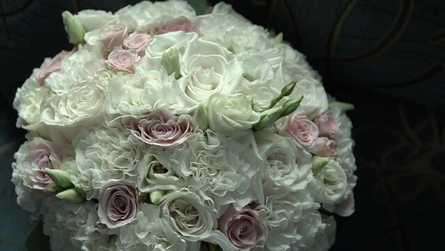 Beautiful modern bridal bouquet on the chair prepared for wedding. Bouquet of fresh roses.