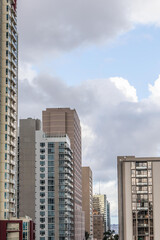 Fototapeta na wymiar Various high rise buildings in major American city with hills in distance, vertical