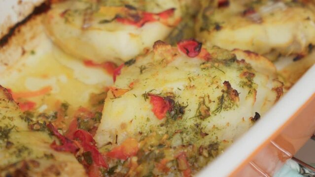 Baked cod fish served in bowl. Cooking fish in the oven. Selective focus.