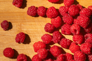 Ripe raspberries on a wooden background. Close up.