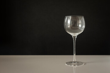 small round shaped wine glass with a dark background