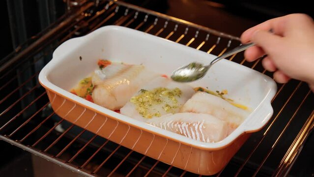 Fillet of fresh sea cod to prepare a healthy healthy dish with salt, ground pepper, fresh seasonal greens.