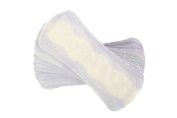 Top view of a stack of purple and white sanitary pads on a white background.
