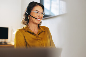 Friendly call center agent answering cals with a headset