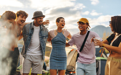 Young friends gather in a circle, drinking cold beer and celebrating a summer festival