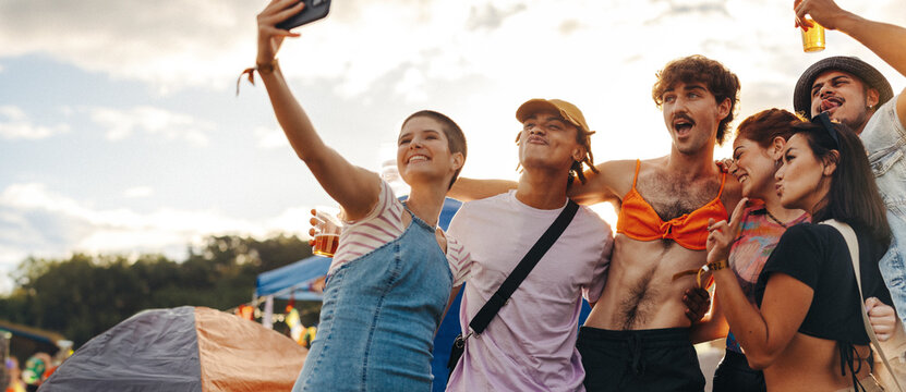 Group of friends taking a selfie at a summer music festival