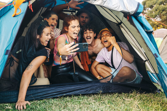 Friends taking selfies at a fun festival camp