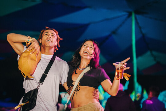 Happy couple dancing and enjoying themselves at a music festival