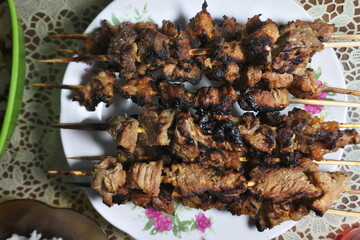 Close up photo of Eid ul Adha slaughtering meat, sate or grilled meat on a white plate