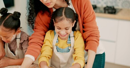 Family, parents and girls with happiness, bake or playful with ingredients, utensils or learning in a kitchen. Mother, father or female children with a recipe, home or excitement with fun or teaching