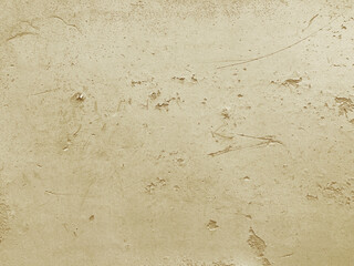  Perforated rough concrete wall. Champagne gold colored grungy textured background.