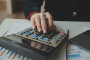 Businessmen are calculating income-expenditure and analyzing real estate investment data, Accounting Financial and tax systems concept.