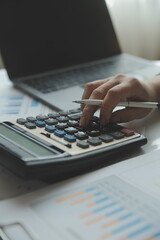 Businessmen are calculating income-expenditure and analyzing real estate investment data, Accounting Financial and tax systems concept.