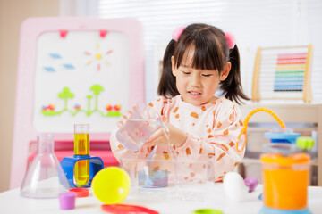 young girl was doing  science experiment at home