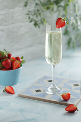 A glass of champagne with strawberries in summer style